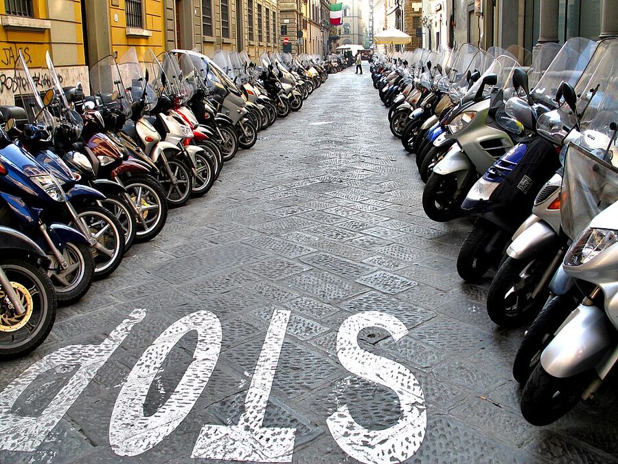 Vespas parked in a row in Florence Italy
