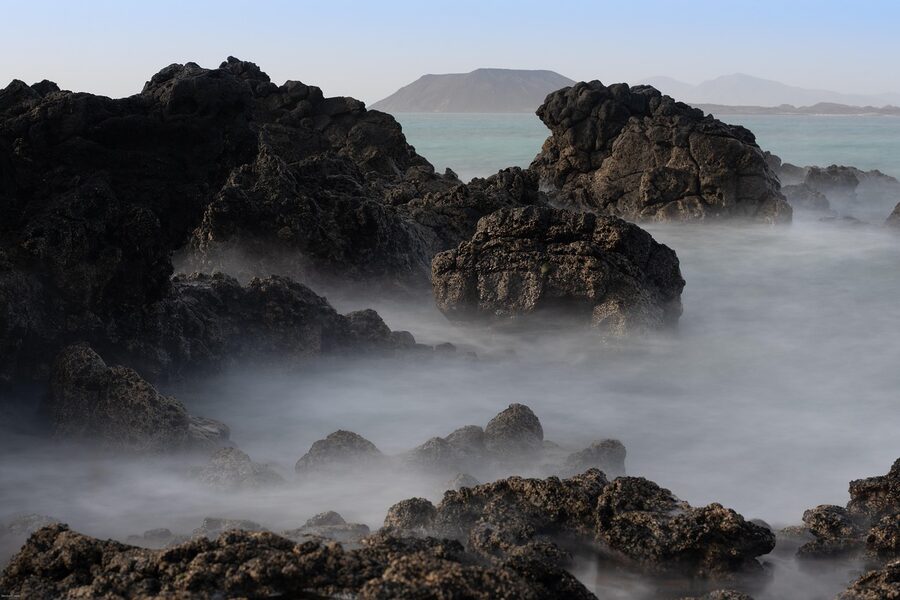 Rocky coast and fog in Fuerteventura morning