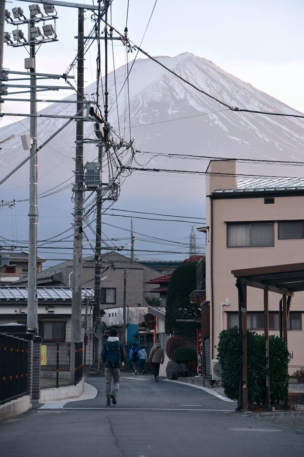 Japanese town street with Mount Fuji and utility poles visible