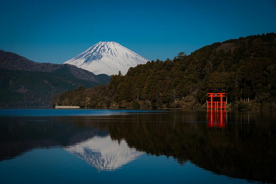 Stunning view of Mount Fuji and a red torii gate reflecting on water