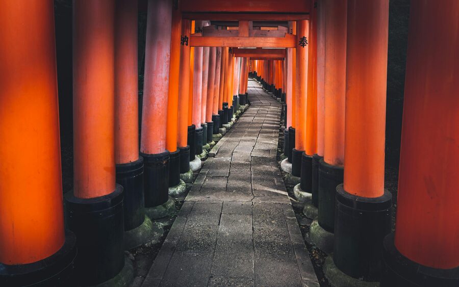 Wide shot of the famous red torii gates at Fushimi Inari Shrine Kyoto