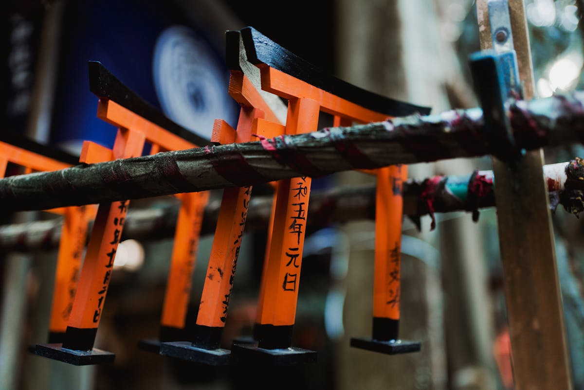 Close-up of miniature votive torii gates with inscriptions at Fushimi Inari
