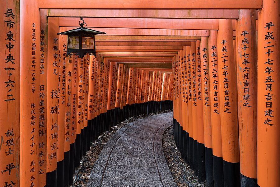 Fushimi Inari torii path with hanging lantern