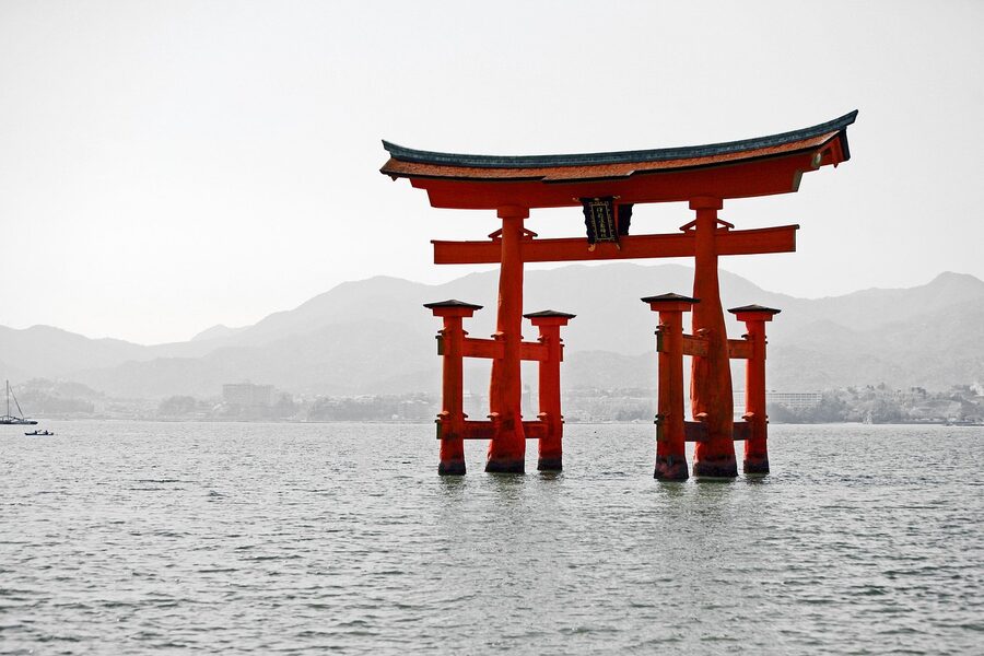 The vermillion Itsukushima Shrine buildings and great torii gate at Miyajima island