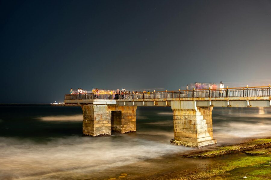 Galle Face pier at night with travellers enjoying the Colombo seafront