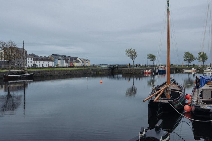 Galway harbour with sailboats and historic buildings