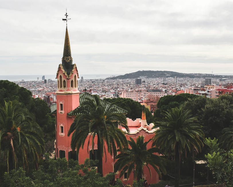 Park Guell with Gaudi House Museum pink spire and Barcelona view