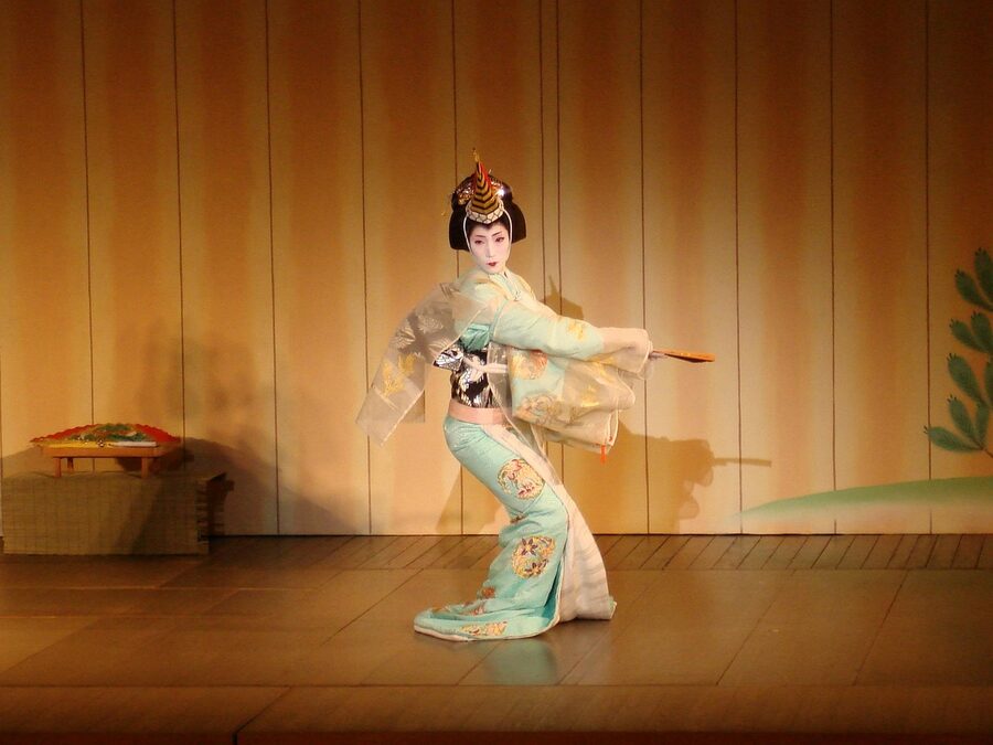 Geisha performing traditional dance on stage in Japan