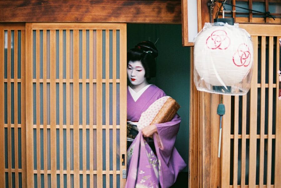 Geisha in purple kimono leaving Kyoto tea house