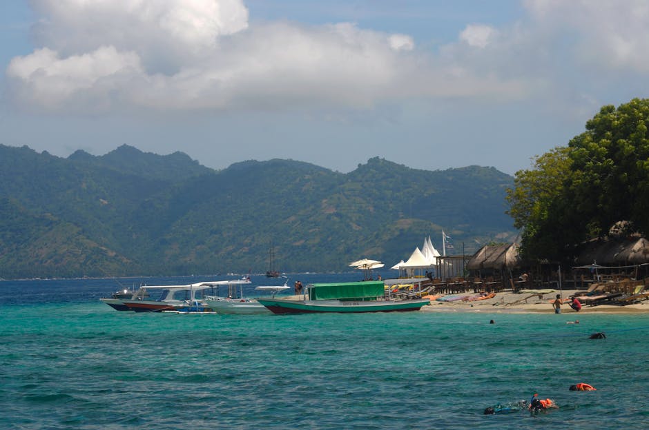 Tropical beach with traditional boats on turquoise water in West Nusa Tenggara Indonesia