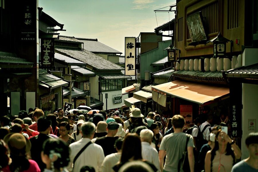 Busy pedestrian street in Kyoto with traditional Japanese buildings