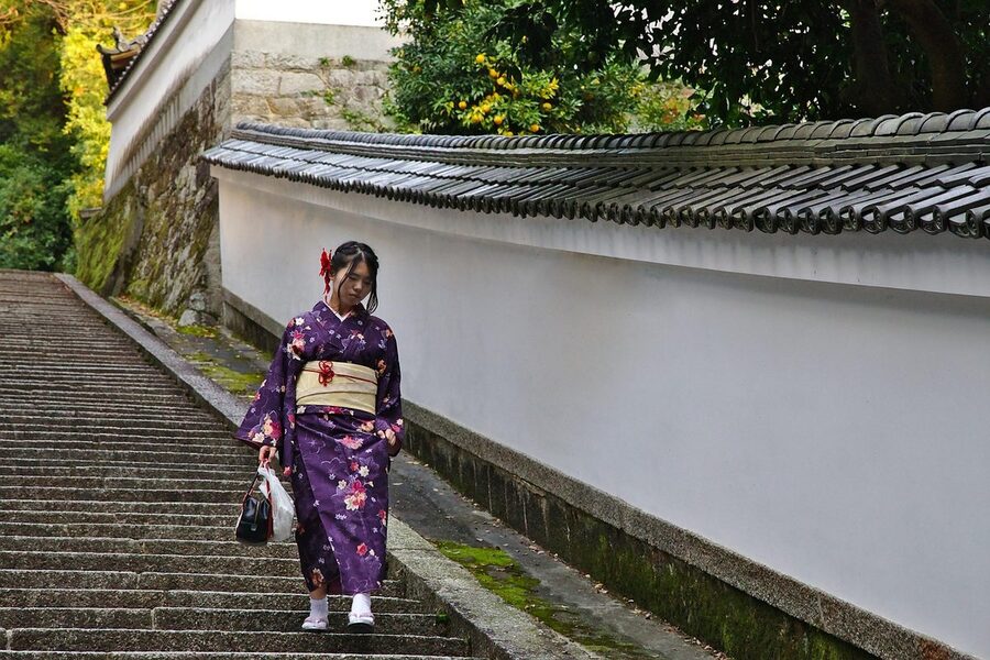 Young woman wearing a colorful kimono walking in the Gion district of Kyoto