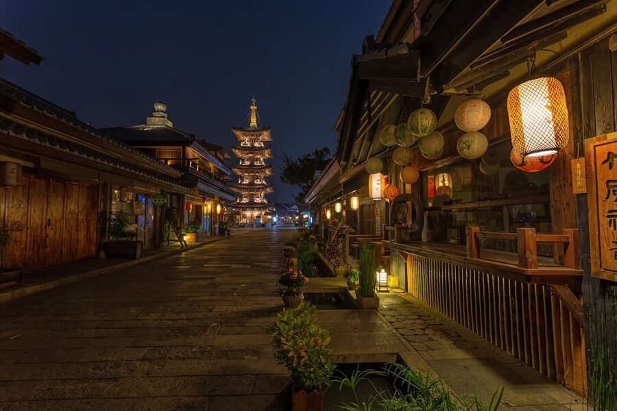 Traditional wooden street with hanging lanterns at dusk in Kyoto