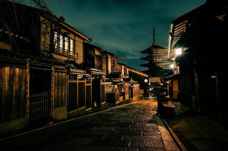 Five-story pagoda and traditional buildings illuminated at night in Gion, Kyoto