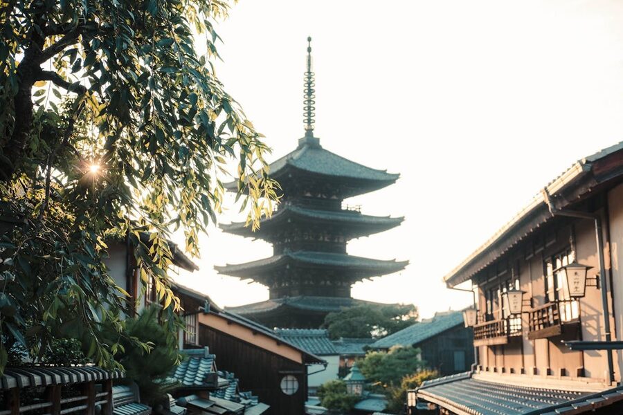 Yasaka Pagoda rising above trees at sunset in Kyoto Higashiyama district