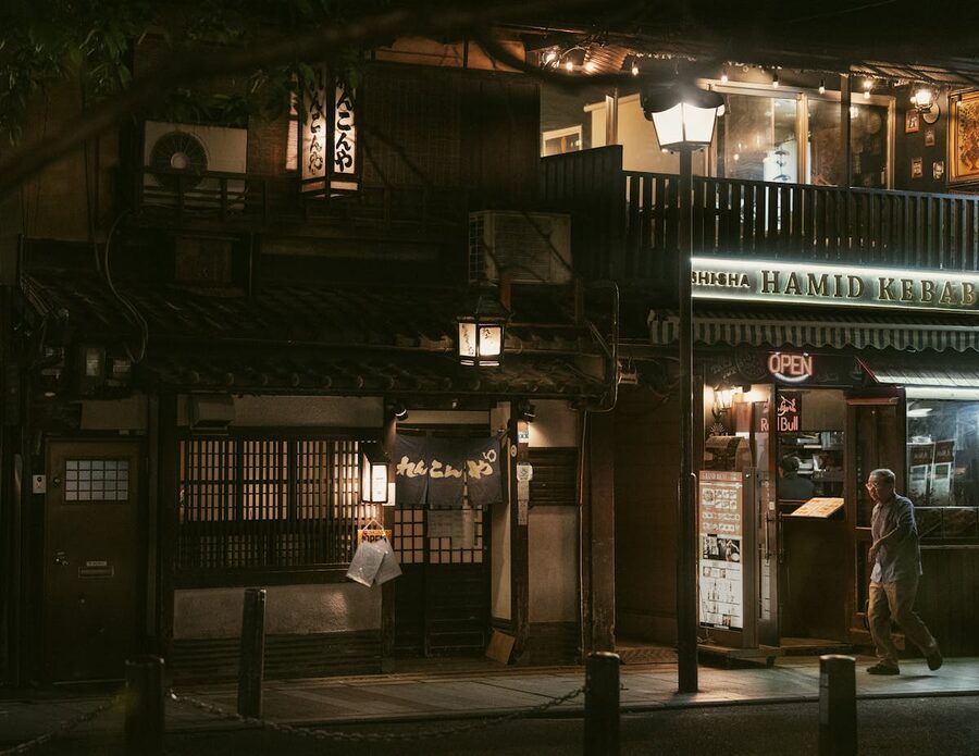 A quiet evening scene in Kyoto Gion District featuring traditional Japanese architecture and warm lighting