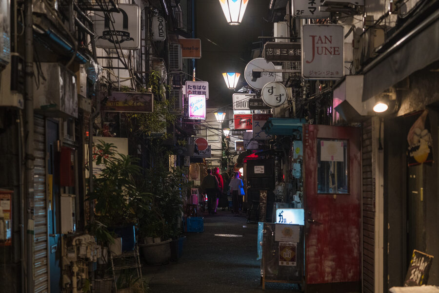 Atmospheric night view of Golden Gai bar district in Shinjuku with narrow lanes and tiny bars