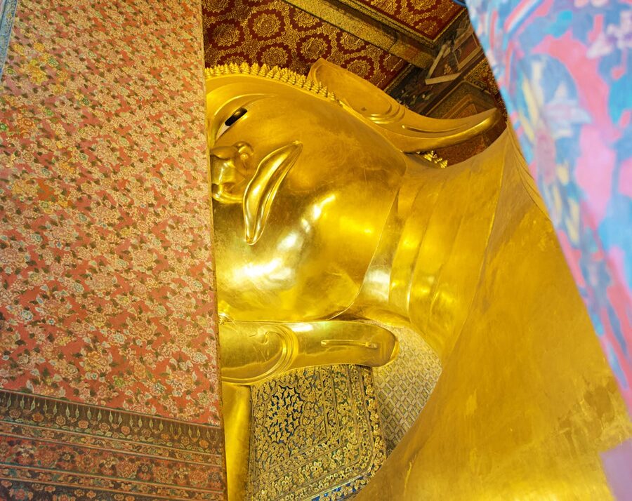 Close-up of the golden Reclining Buddha statue at Wat Pho temple in Bangkok