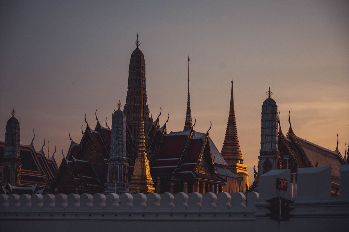 Dramatic sunset over the spires of Wat Phra Kaew temple in Bangkok Thailand