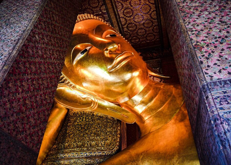 Massive golden Reclining Buddha statue inside Wat Pho temple in Bangkok Thailand