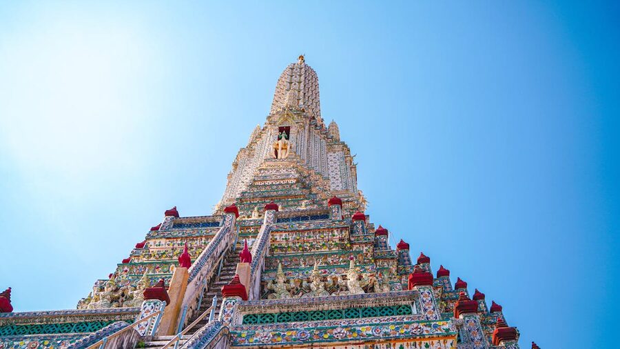 Intricate porcelain mosaic details on the central tower of Wat Arun temple in Bangkok