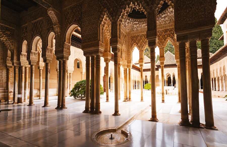 Carved arches and columns inside an Alhambra courtyard