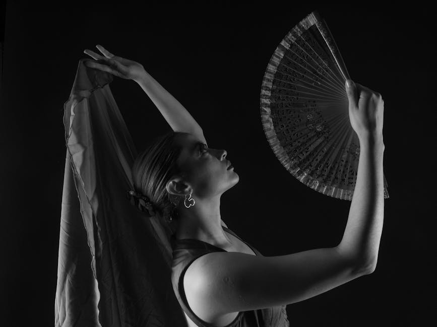 Flamenco dancer in a graceful pose with a fan