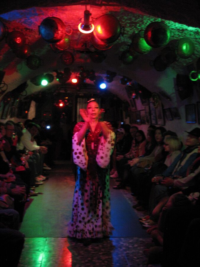 Flamenco dancer mid-spin during a Sacromonte cave performance