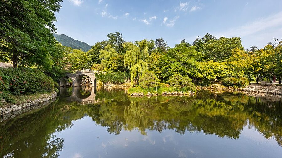 Banya Yeonji pond reflecting a wooden bridge and trees at Bulguksa temple in Gyeongju