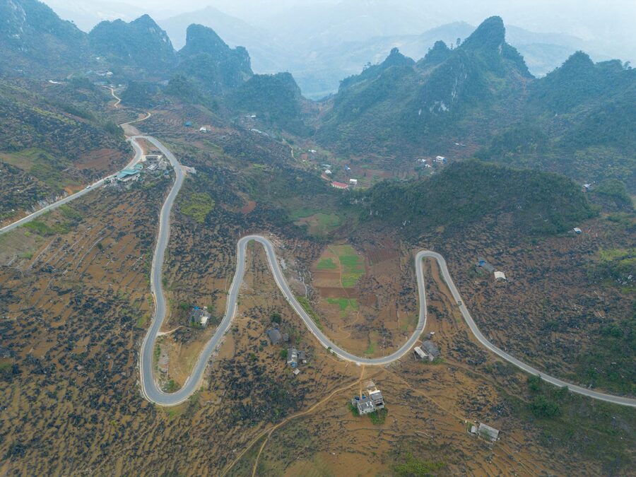 Jagged limestone karst peaks covered in green forest on the Dong Van Karst Plateau