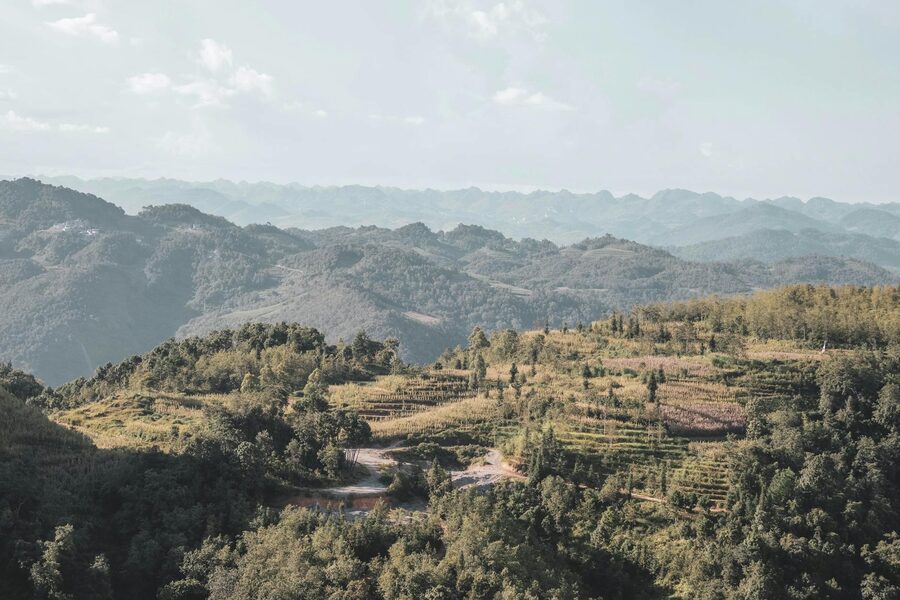 Dramatic limestone peaks towering over a Ha Giang valley at golden hour