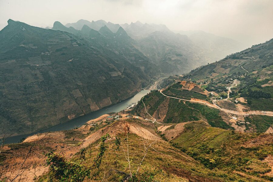 Winding mountain road climbing through the Ha Giang highlands of northern Vietnam