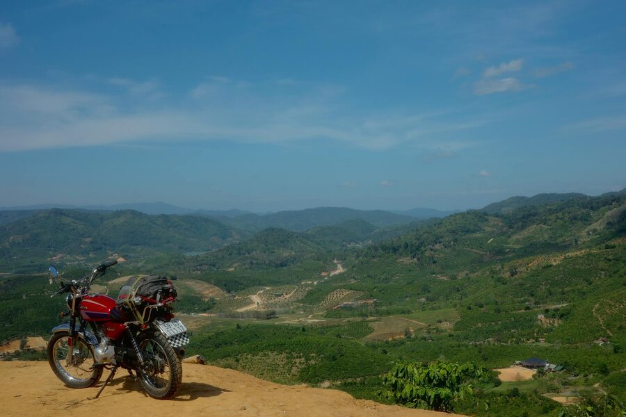 Sweeping curves of Ma Pi Leng Pass carved into the mountain face above a canyon