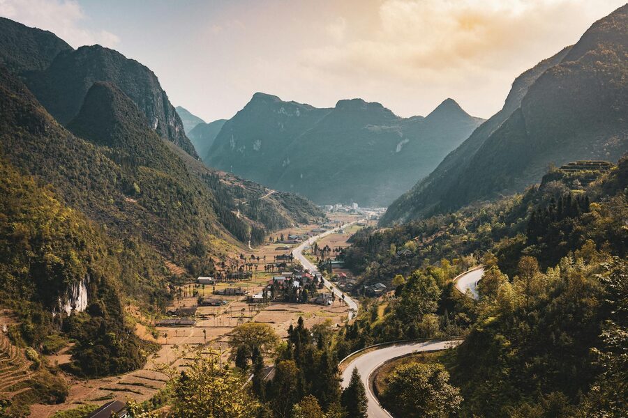 Motorbike trail winding down into a remote valley on the Ha Giang Loop