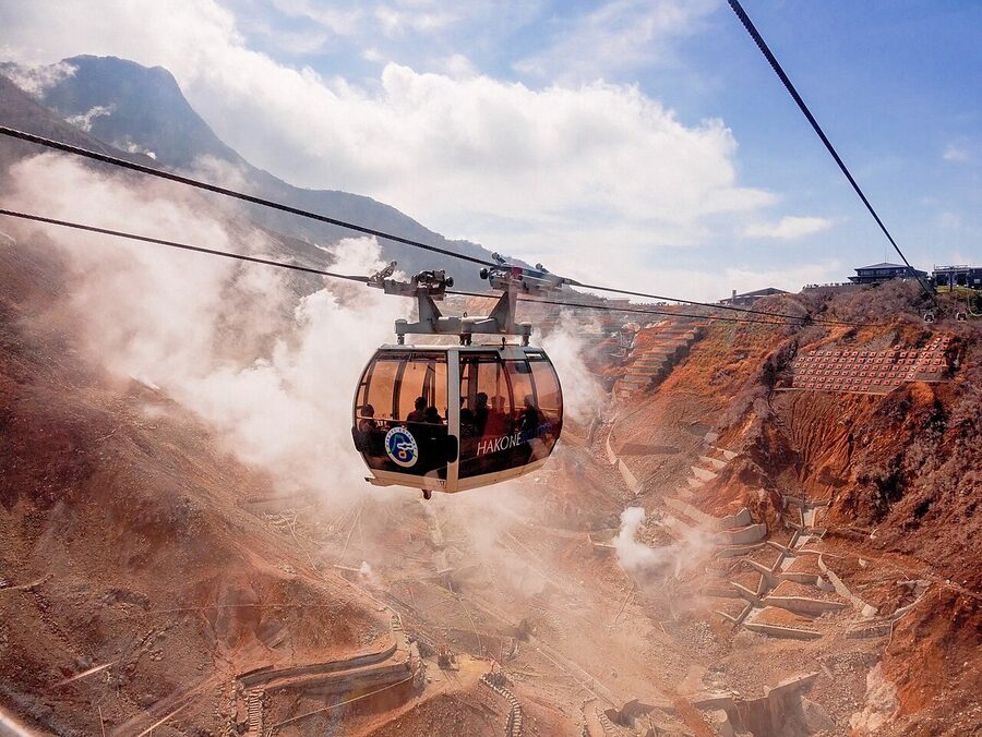 Cable car passing over Owakudani volcanic valley in Hakone