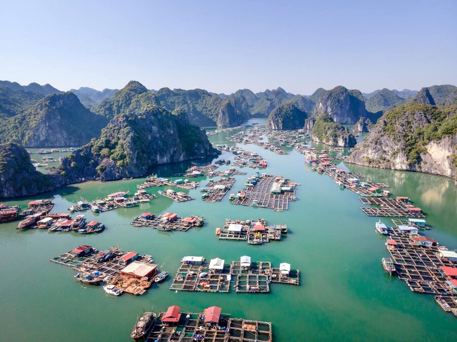 Aerial view of Cat Ba Island with floating fishing villages and cliffs