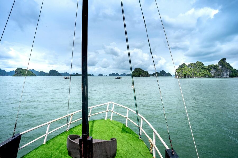 View from sailboat deck looking out at Ha Long Bay in Vietnam