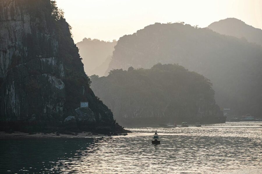 Ha Long Bay with limestone cliffs in soft evening light