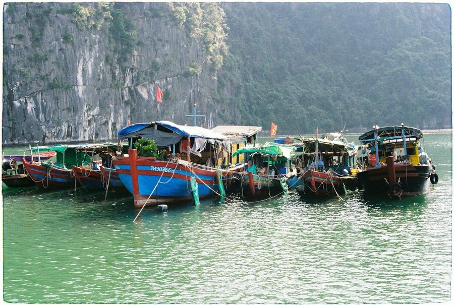 Traditional wooden fishing boats in Lan Ha Bay Vietnam