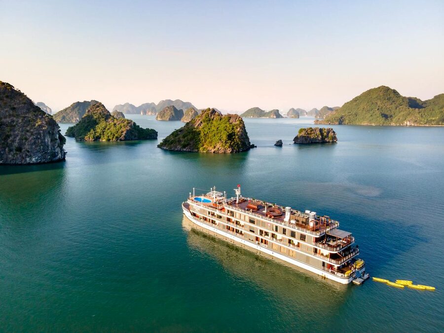 Luxury cruise ship navigating limestone islands of Halong Bay