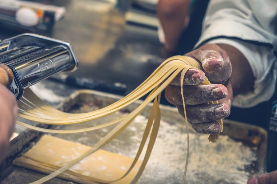 Hands shaping fresh pasta at a Florence pasta-making class