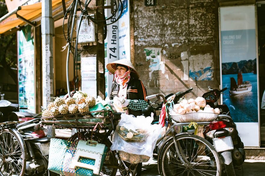Group of travellers eating pho at a street stall during a Hanoi food tour