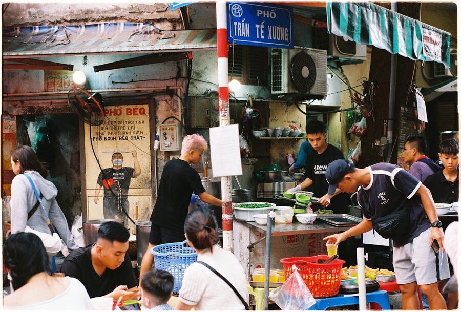 Local cook preparing traditional Vietnamese dishes at a street stall in Hanoi