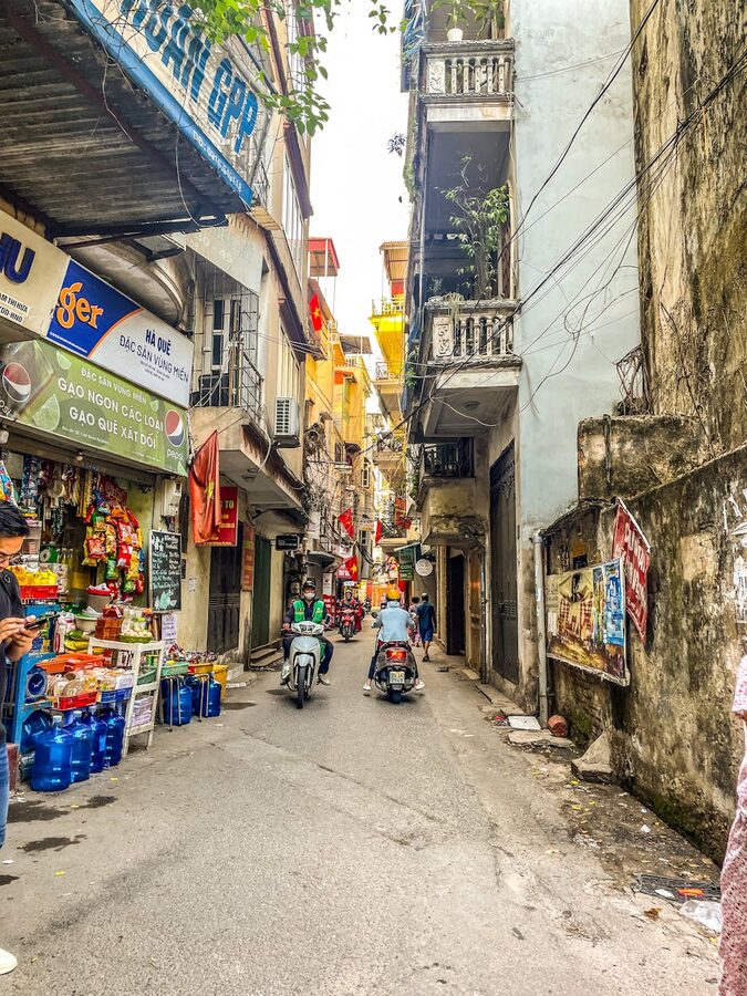 Shops and motorbikes on a street in Hanoi Old Quarter