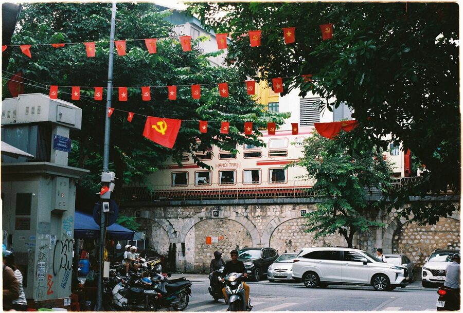 Train passing through the narrow streets of Hanoi Old Quarter