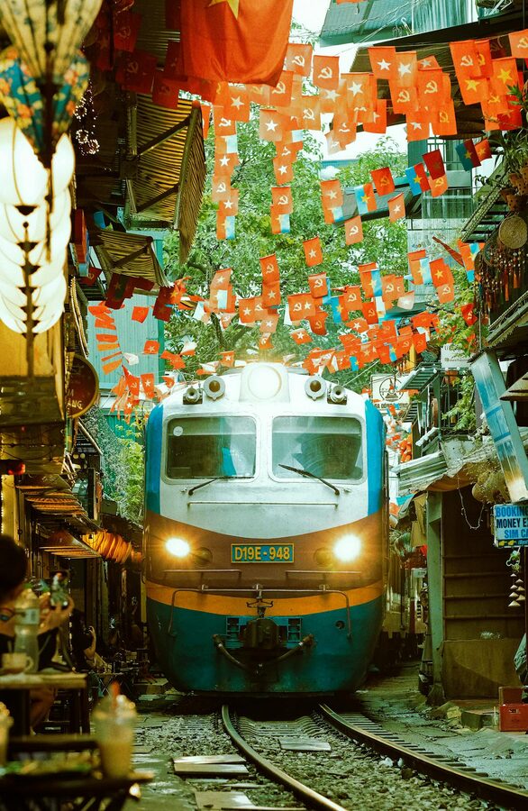 Railway tracks running between buildings in Hanoi Train Street neighborhood