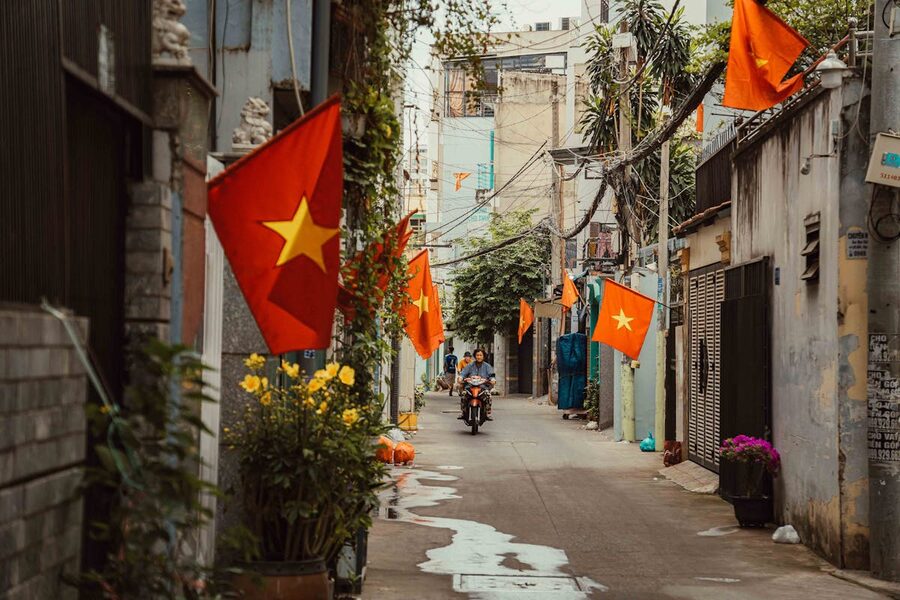 An alley in Ho Chi Minh City adorned with Vietnamese flags