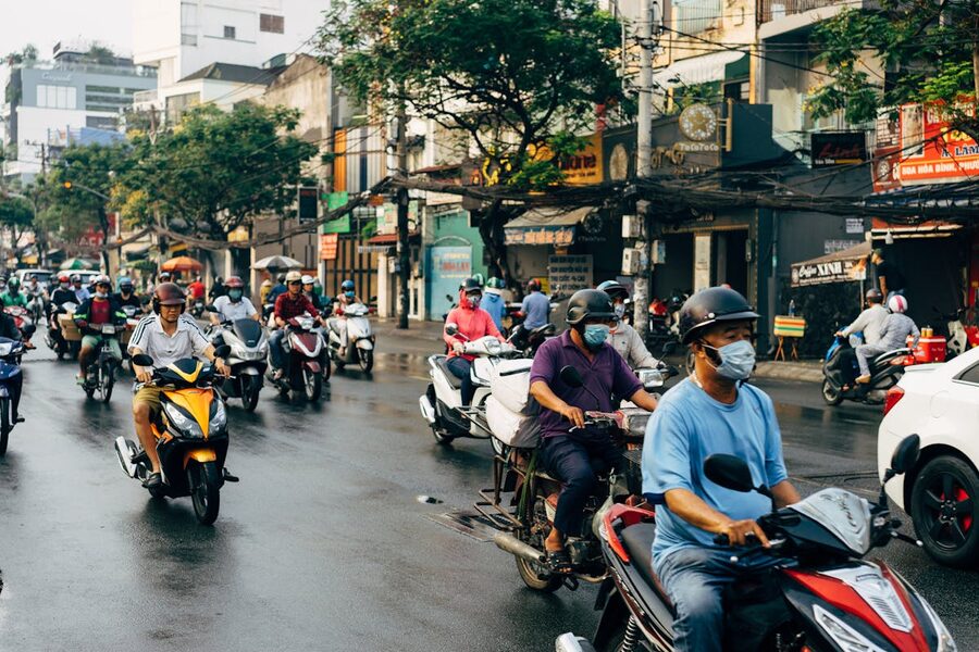 Motorcyclists riding through Ho Chi Minh City streets