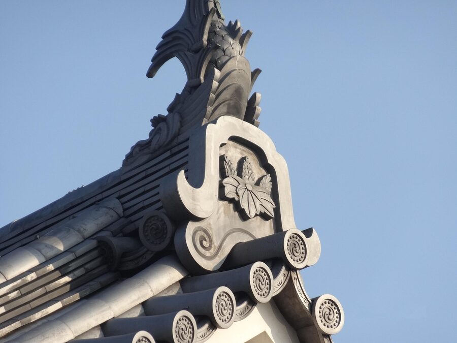 Detailed view of Hiroshima Castle roof tiles against a blue sky