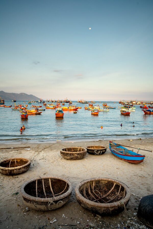 Traditional Vietnamese basket boats at sunset on the coast